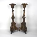 Pair of chiseled brass candlesticks with religious relief designs, 80 cm