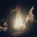 Photograph of a night launch of the shuttle Discovery and Hubble mission