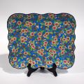 Plat rectangulaire émaillé de fleurs, bords chantournés, dimensions 23 x 27 cm (éclat)