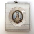 Miniature on bone depicting an elegant young woman holding a rose, 4.5 x 3.5 cm