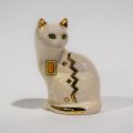 Sculpture of a cat sitting in cracked earthenware