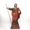 A 17th-century carved wooden figure of a saint, polychrome and in the round