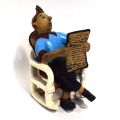 (TINTIN) Wooden figurine of Tintin reading a newspaper, sitting on a rocking chair, from the comic strip by HERGÉ "Tintin in the Congo", height: 29 cm, hand painted