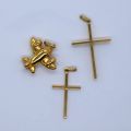 18ct gold lot: cross, airplane and character pendants, 9.82g total