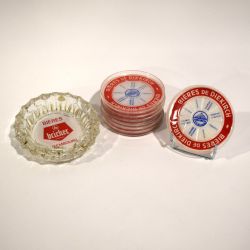 Collection of vintage brewery ashtrays and coasters